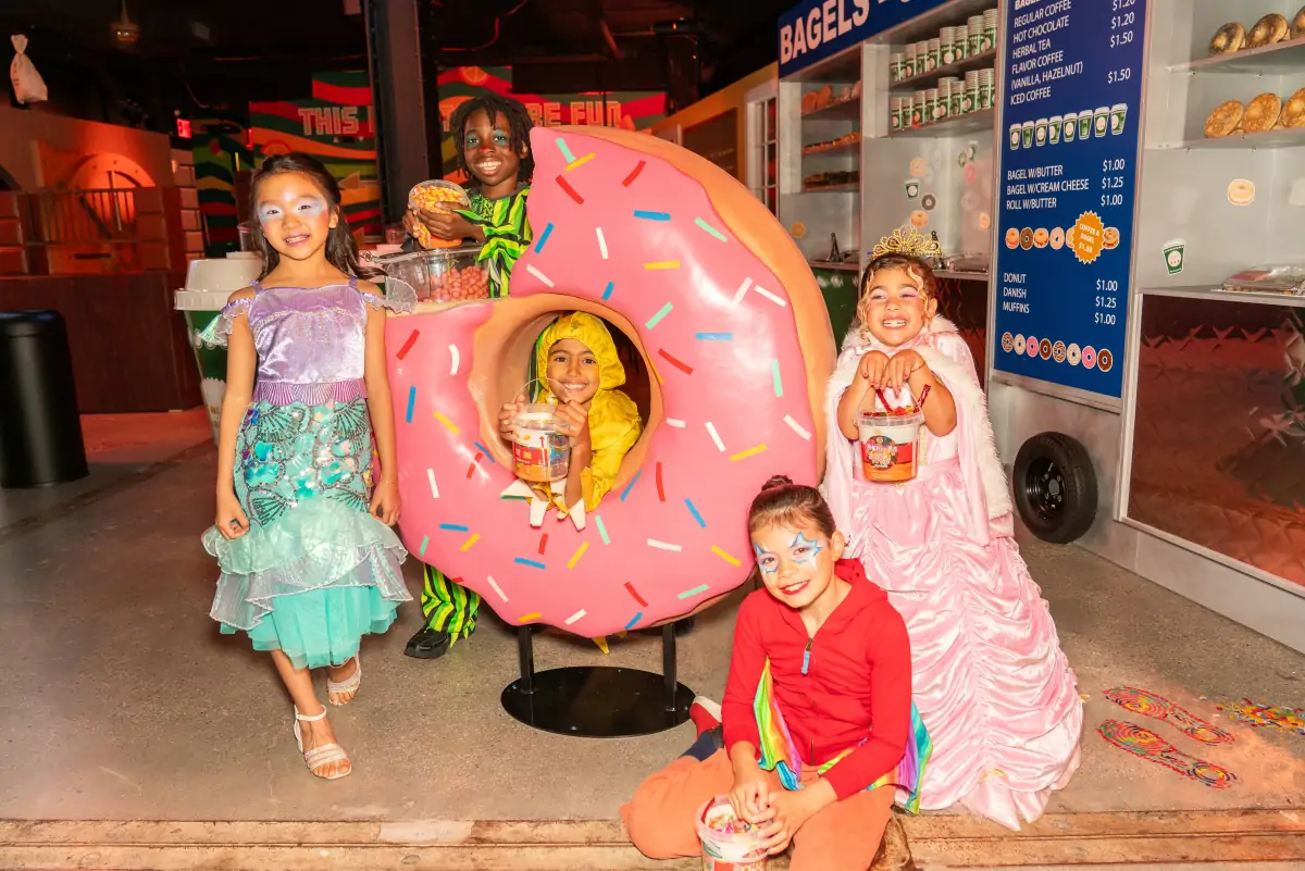 Visitors exploring a candy-themed neighborhood at One Times Square Candy Experience
